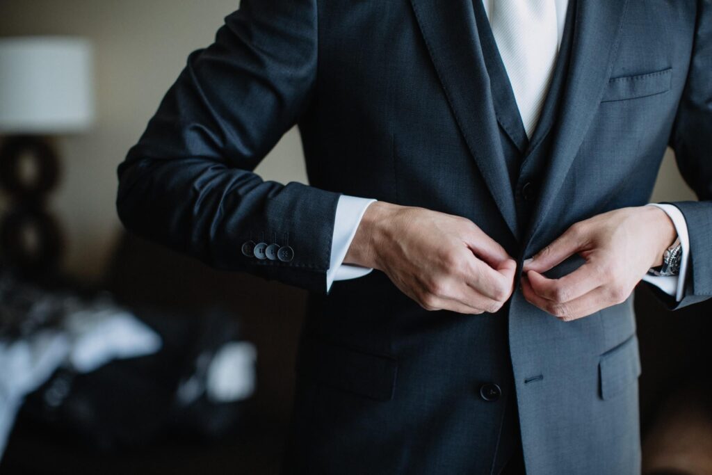 diverse-young-man-getting-ready-and-putting-on-his-suit-and-tie-formal-evening-wear-business-attire_t20_koe3aE.jpg